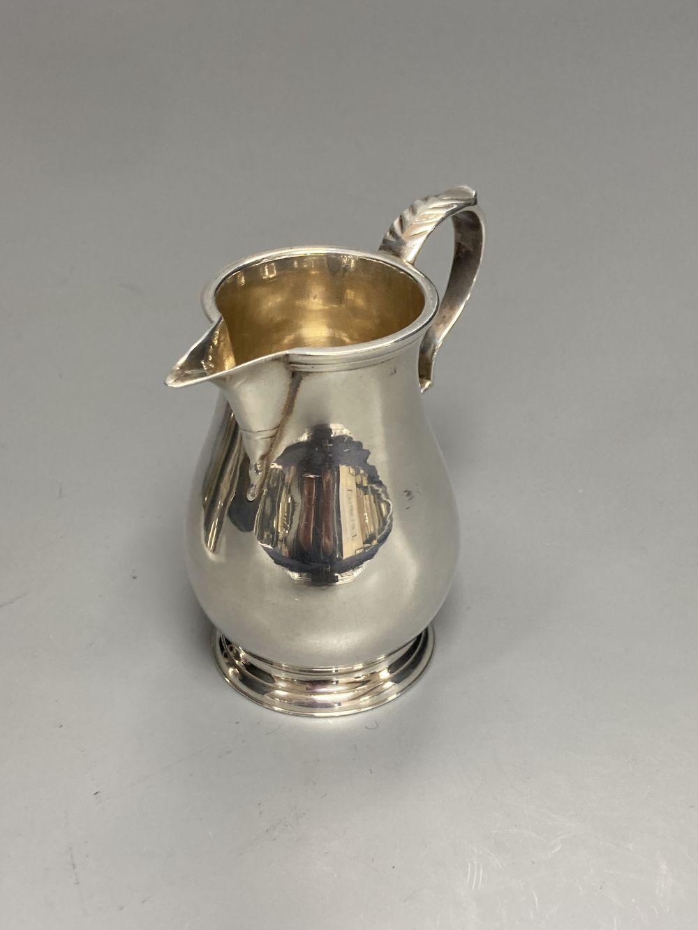A George V Brittania standard silver sparrow beak cream jug, London, 1910 and an earlier silver two handled sugar bowl,